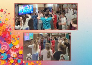 Uczniowie tańczą i bawią się, naśladując ruchy z gry wyświetlanej na ekranie.